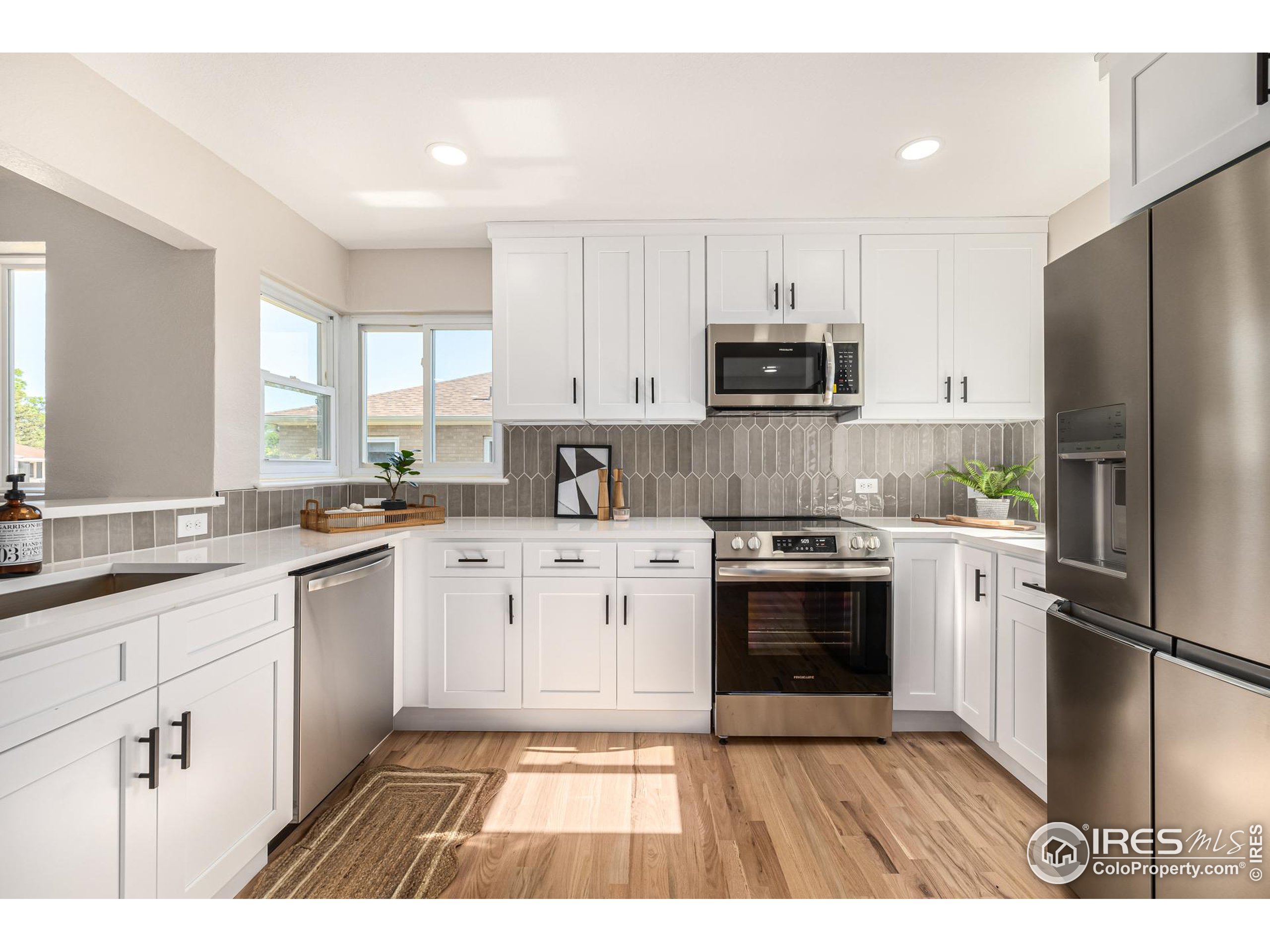 a kitchen with a sink stove and refrigerator