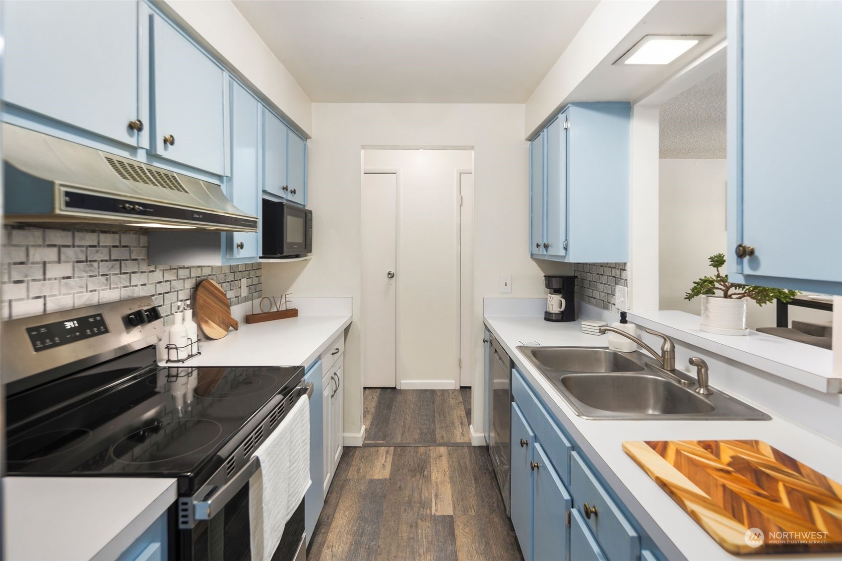 a kitchen with a sink stove top oven and cabinets