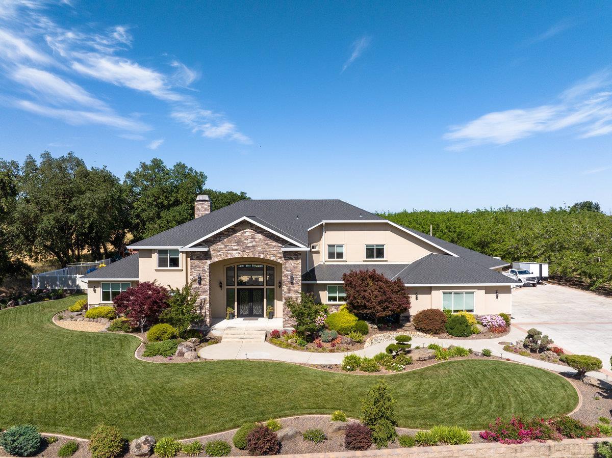 a front view of house with yard and green space