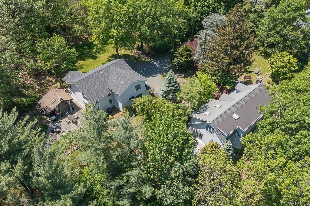 an aerial view of a house with a yard and trees