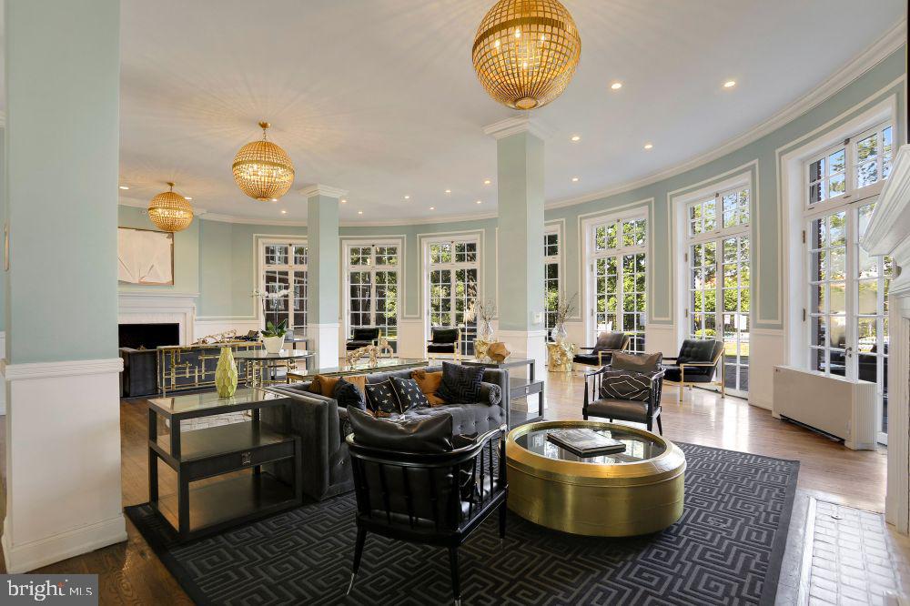 a living room with fireplace furniture and a large window