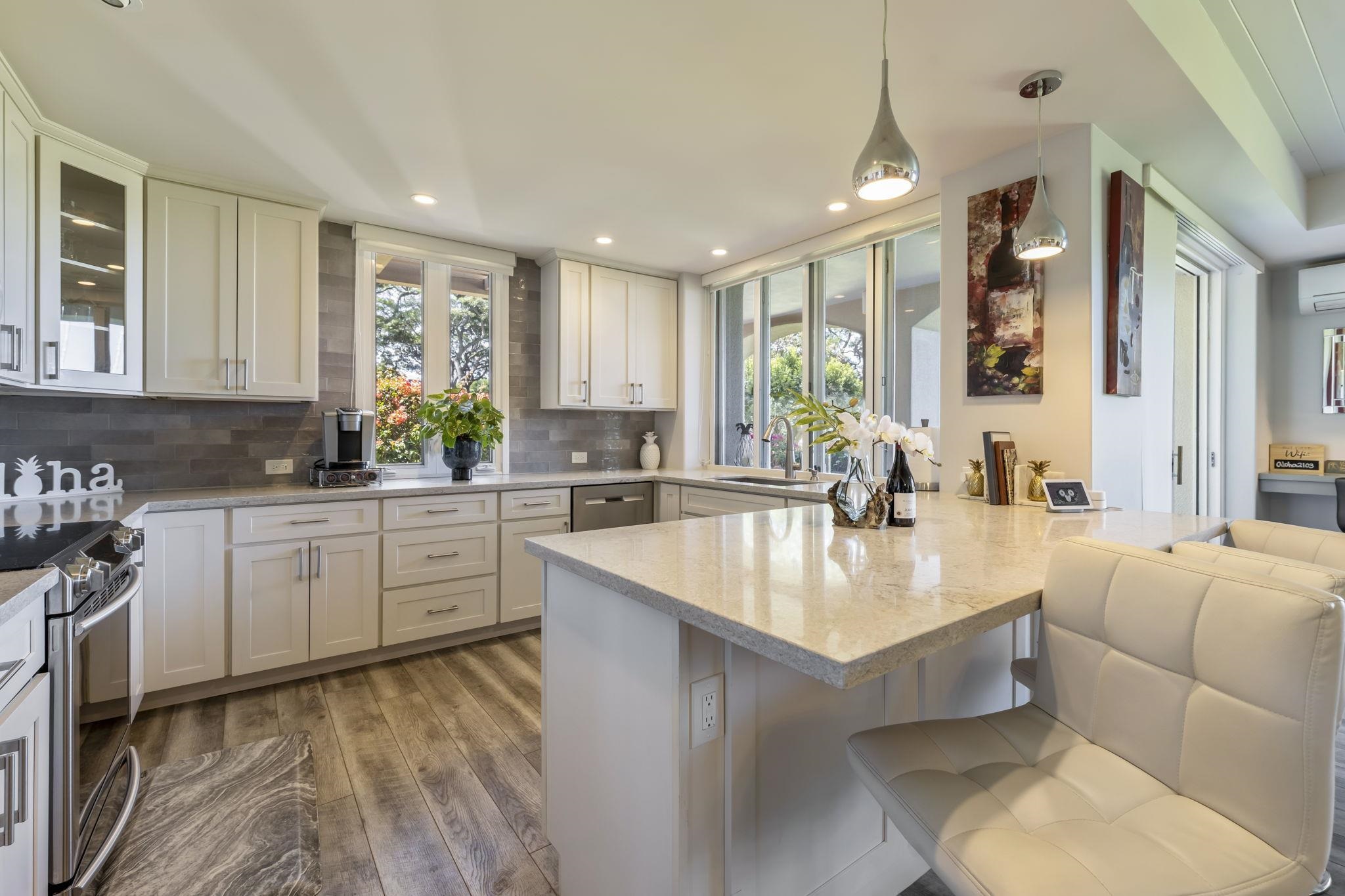 a large kitchen with kitchen island a large window in it