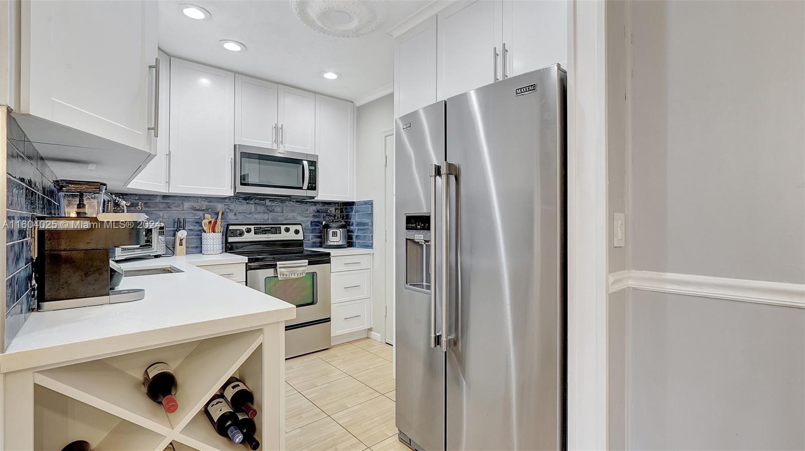 a kitchen with stainless steel appliances a refrigerator stove microwave and sink