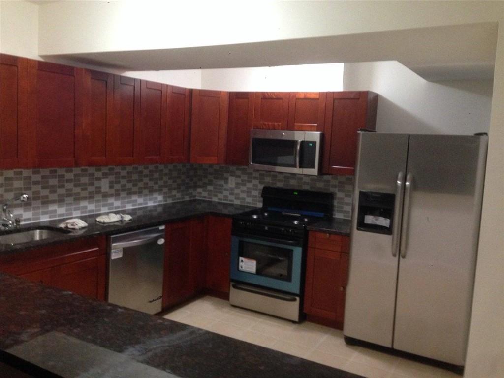 a kitchen with a refrigerator and a sink