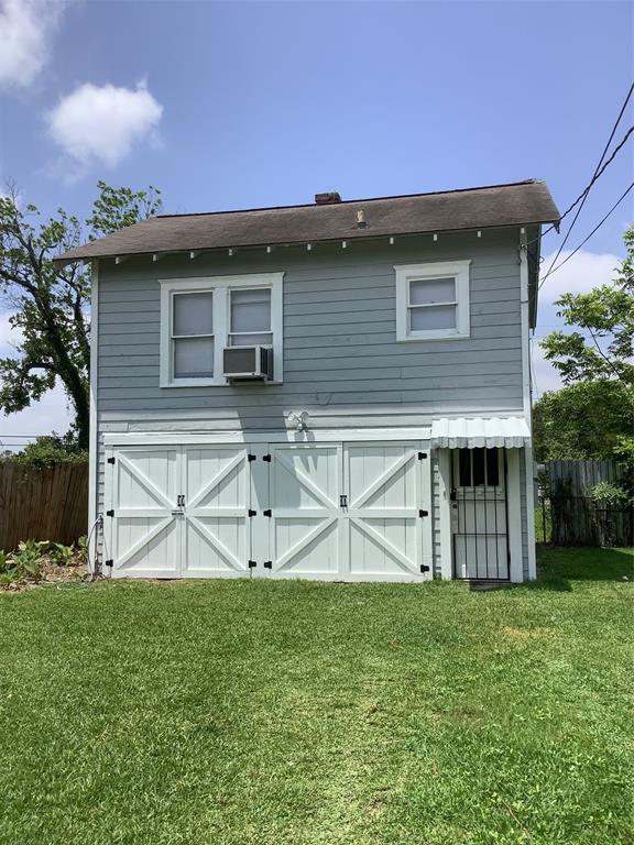 a view of a house with backyard and a chair