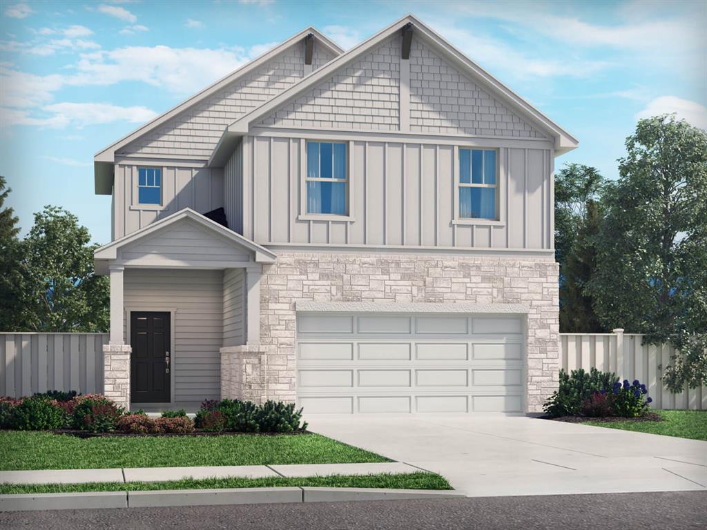 a front view of a house with a garden and garage