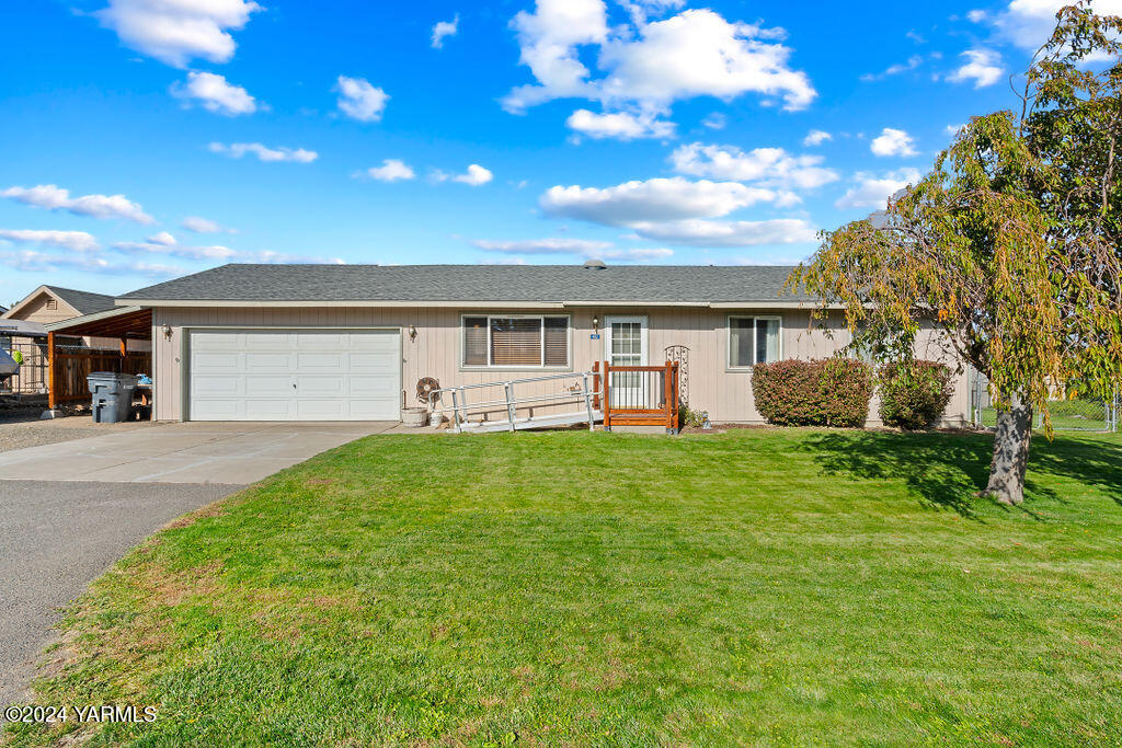 a front view of a house with a yard and garage