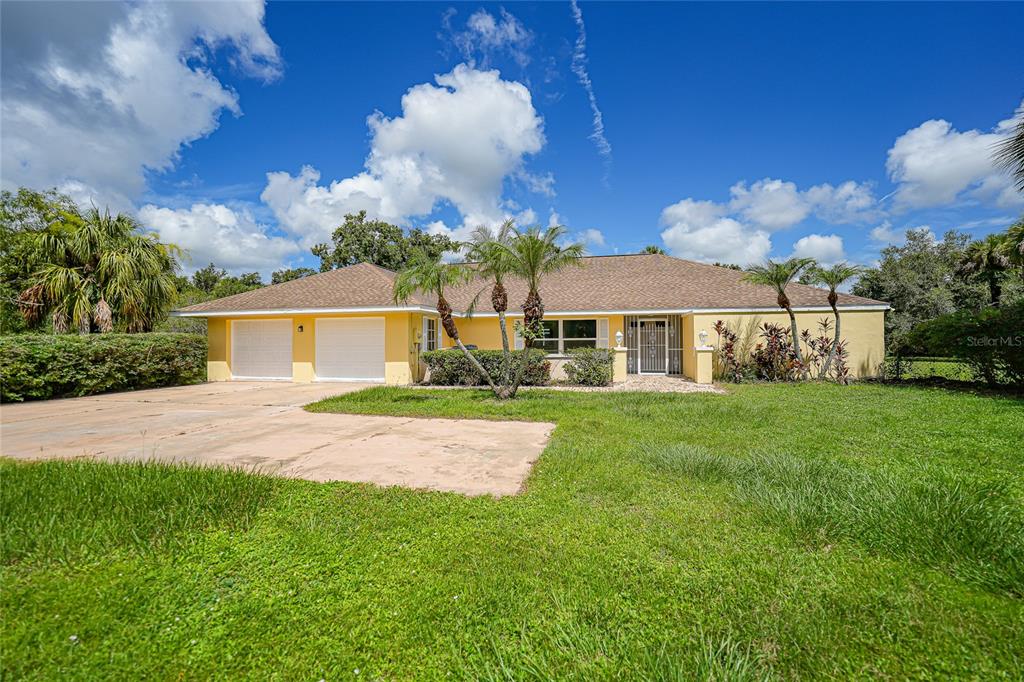 a front view of house with yard and green space