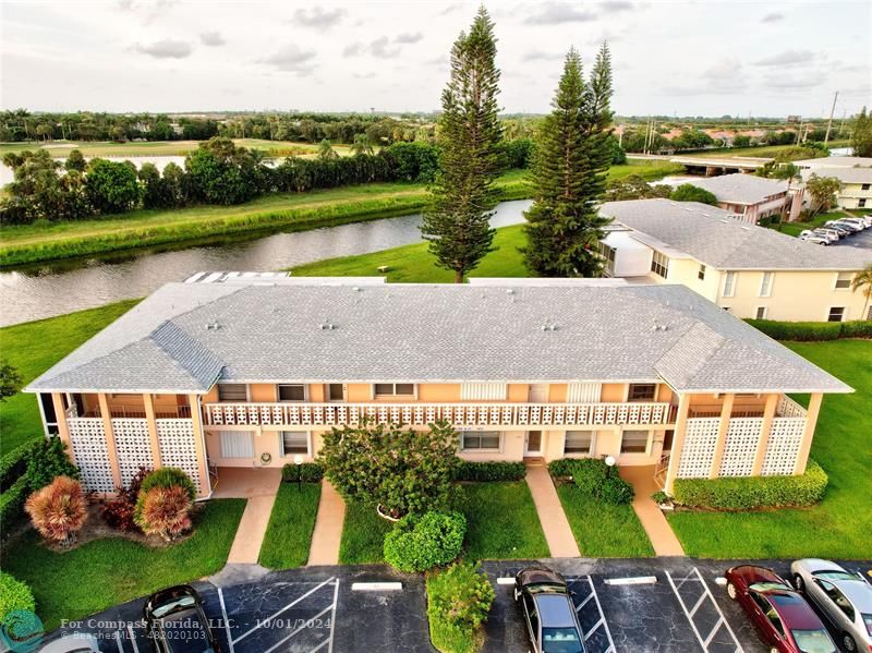 an aerial view of a house with garden space and outdoor seating