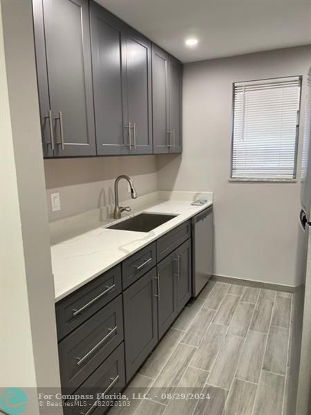 a kitchen with a sink and cabinets