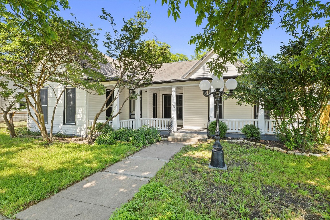 a front view of house with yard and green space