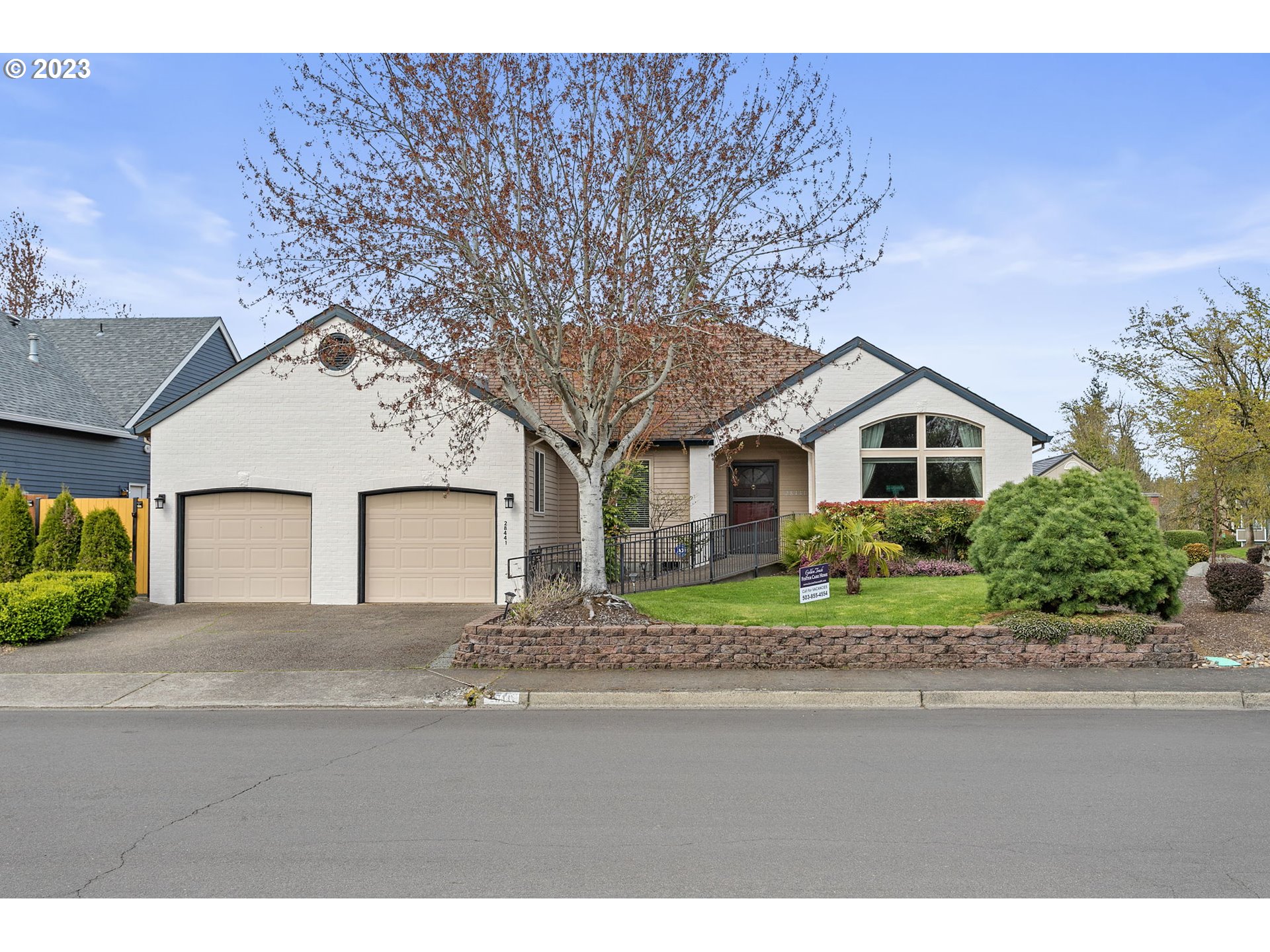 a front view of a house with a yard and garage