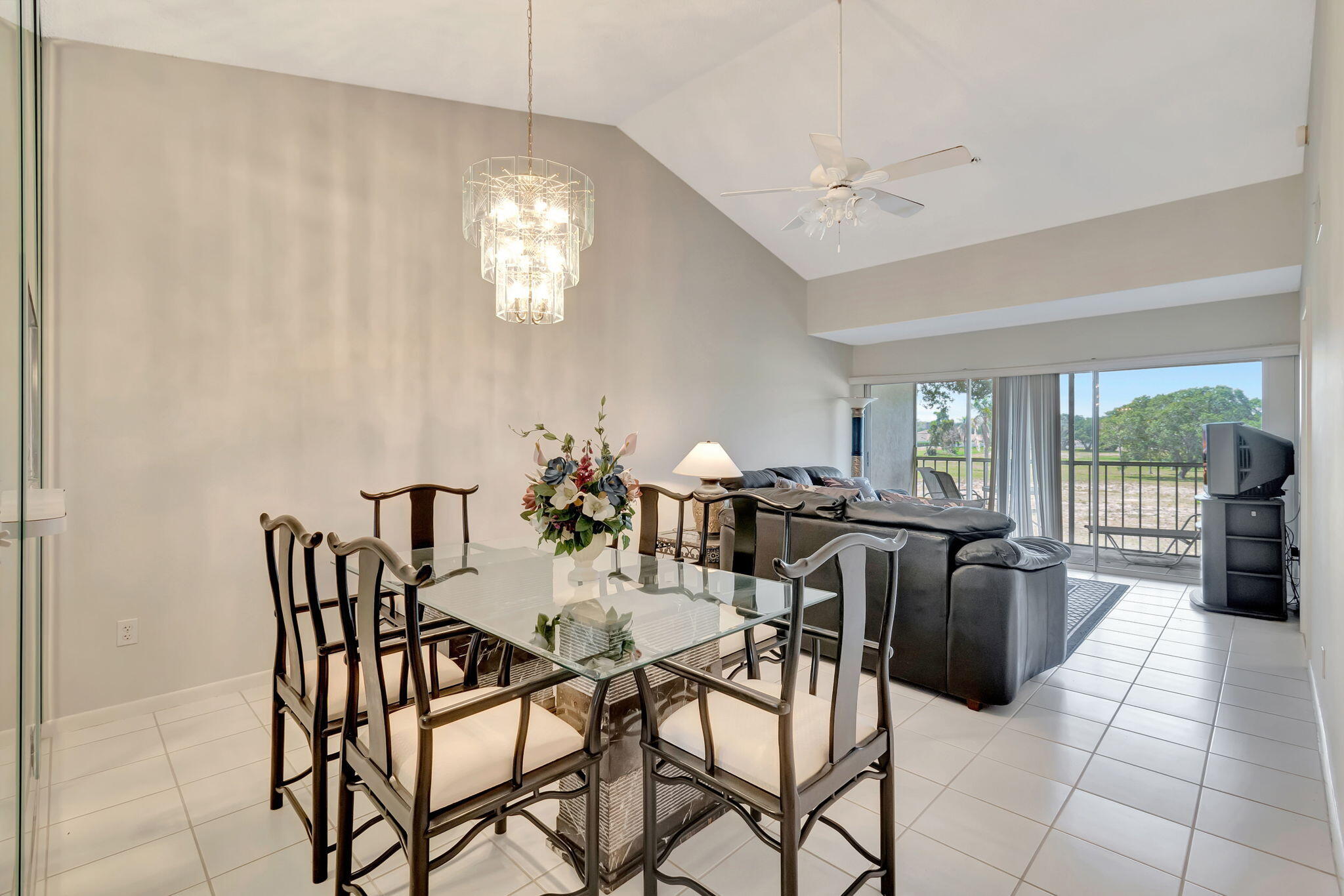 a view of a dining room with furniture and a chandelier