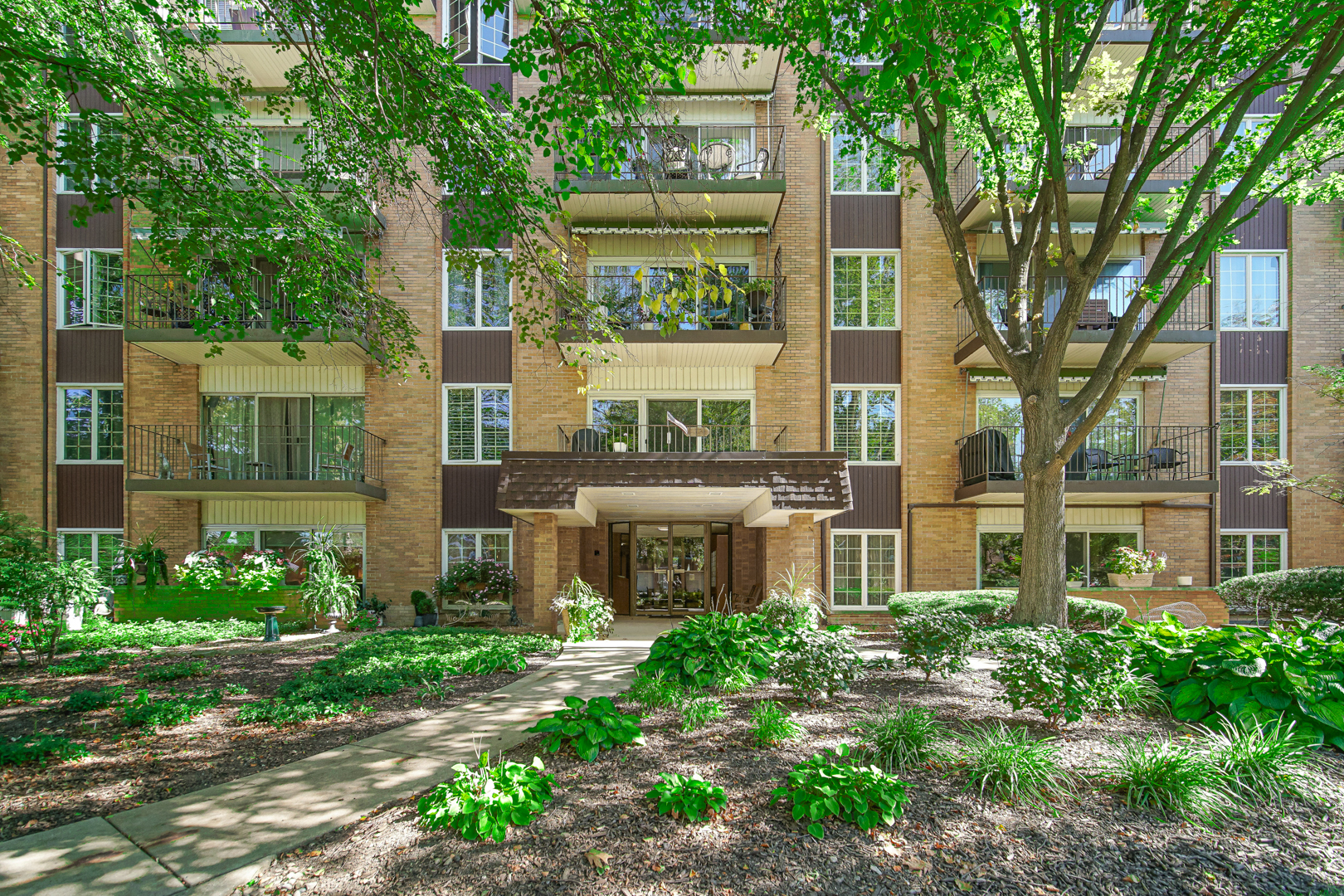 front view of a building with a garden