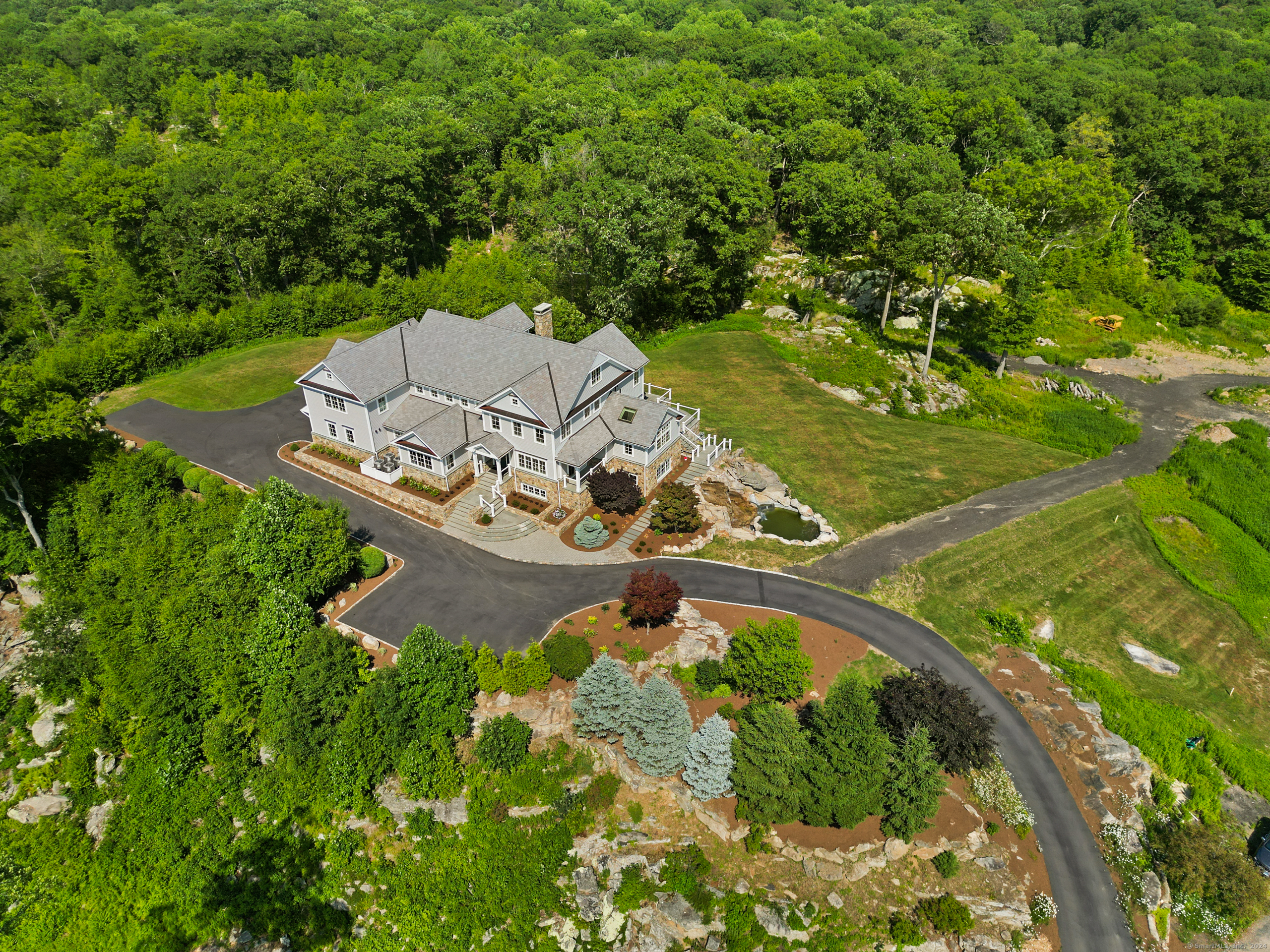 an aerial view of a house with a yard