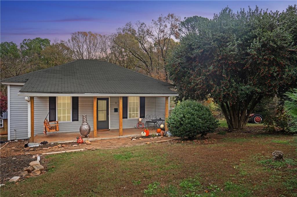 a view of a house with backyard and trees