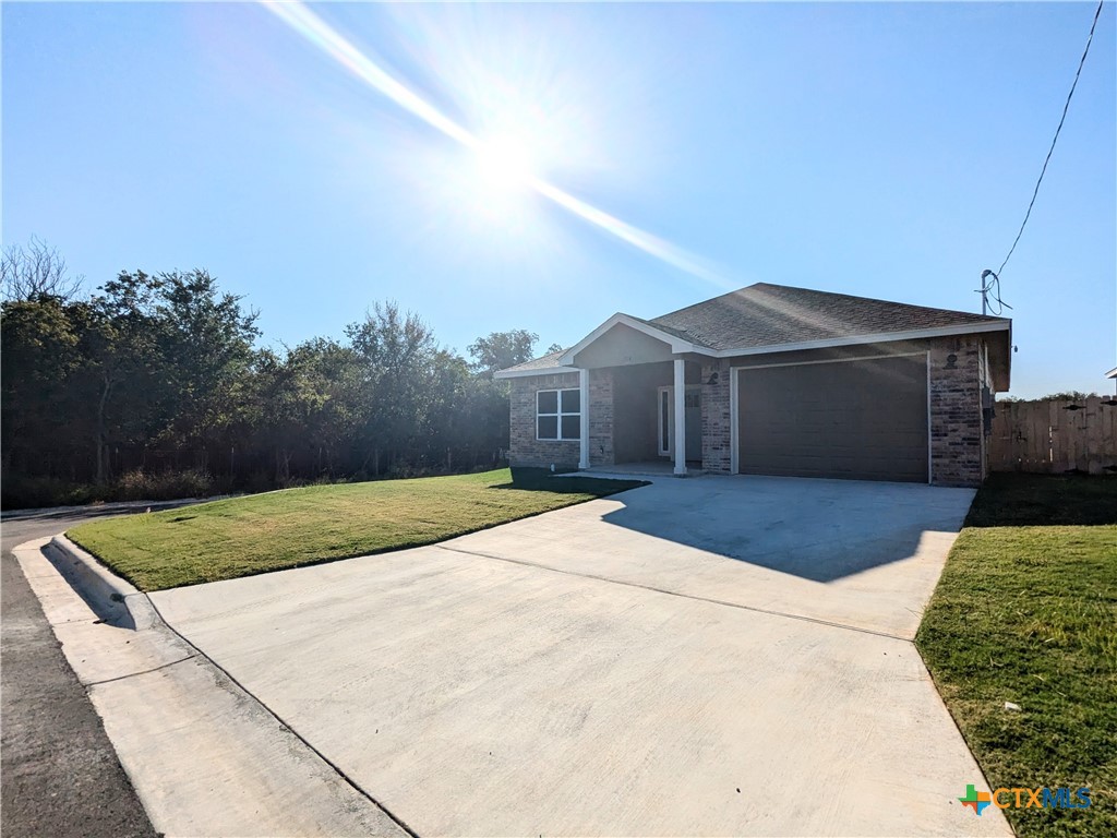 a front view of a house with yard and garage