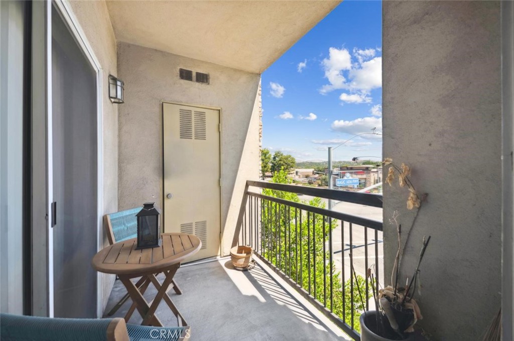 a view of a balcony with furniture