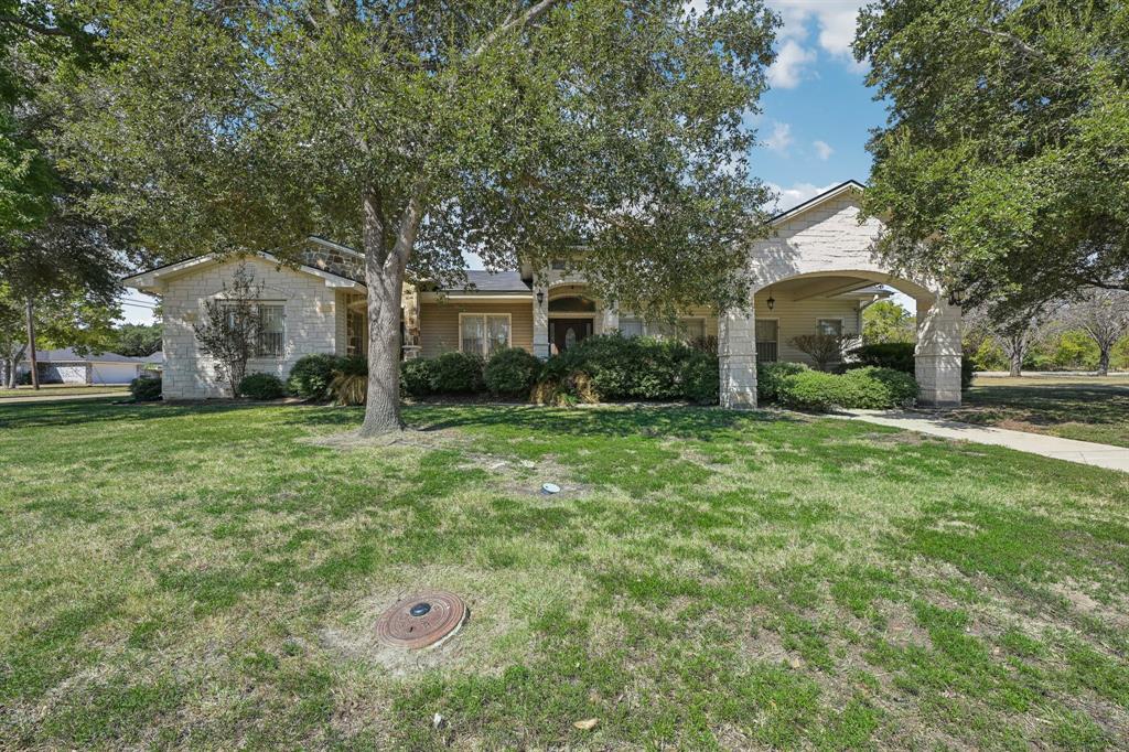 a front view of house with yard and green space