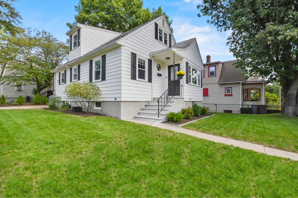 a front view of house with yard and green space