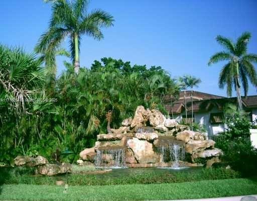 a garden view with a fountain