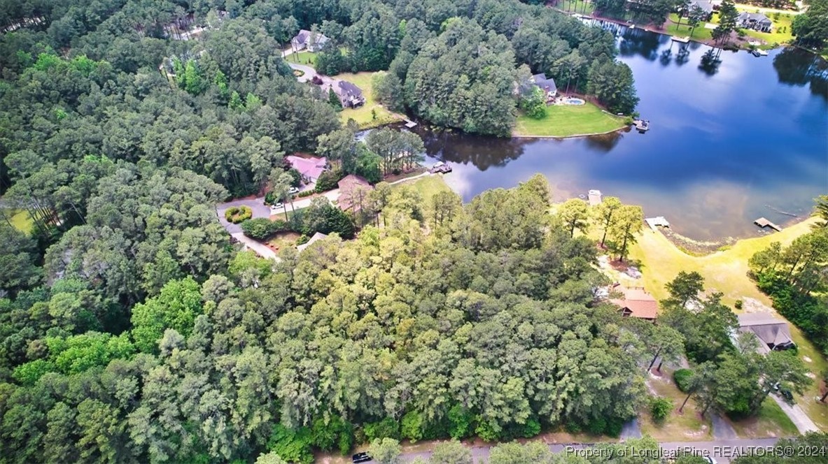 an aerial view of a house with a yard and swimming pool