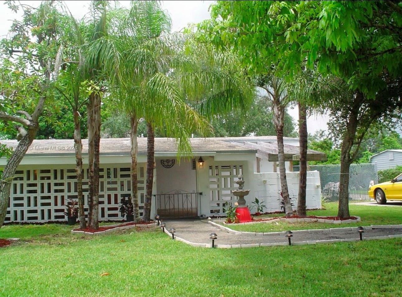 a view of a house with a yard and sitting area