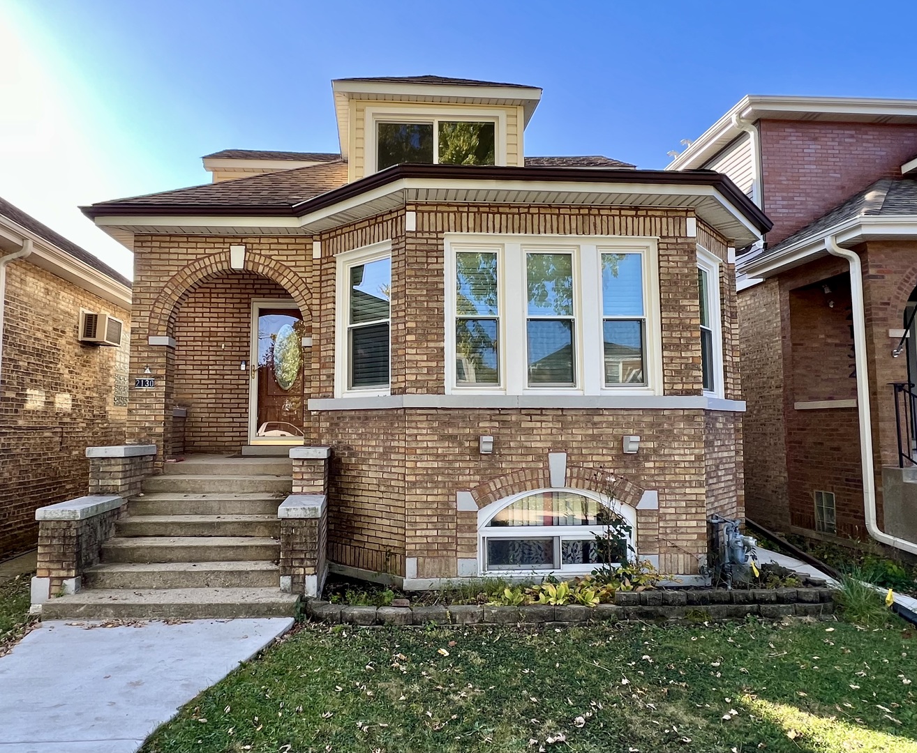 a front view of a house with garden