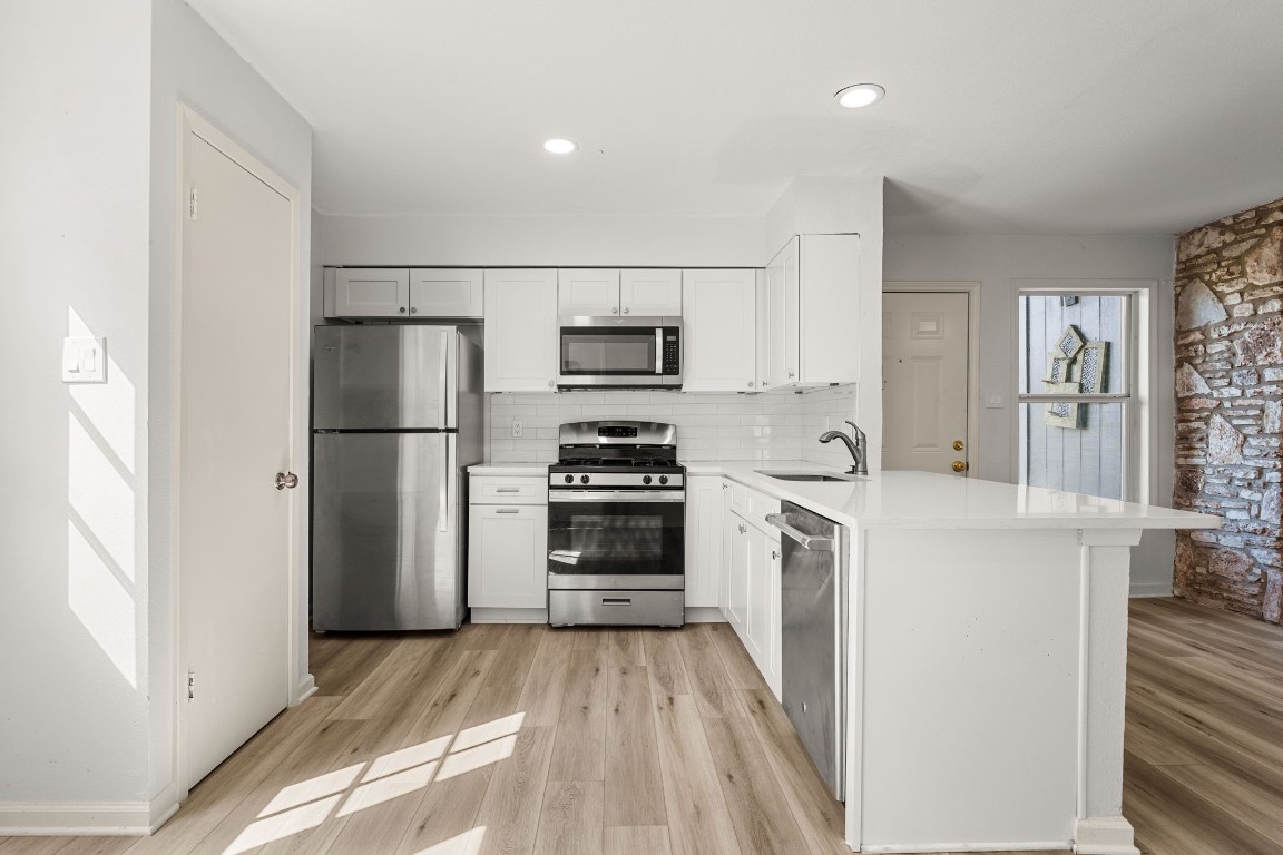 a kitchen with a refrigerator and a stove