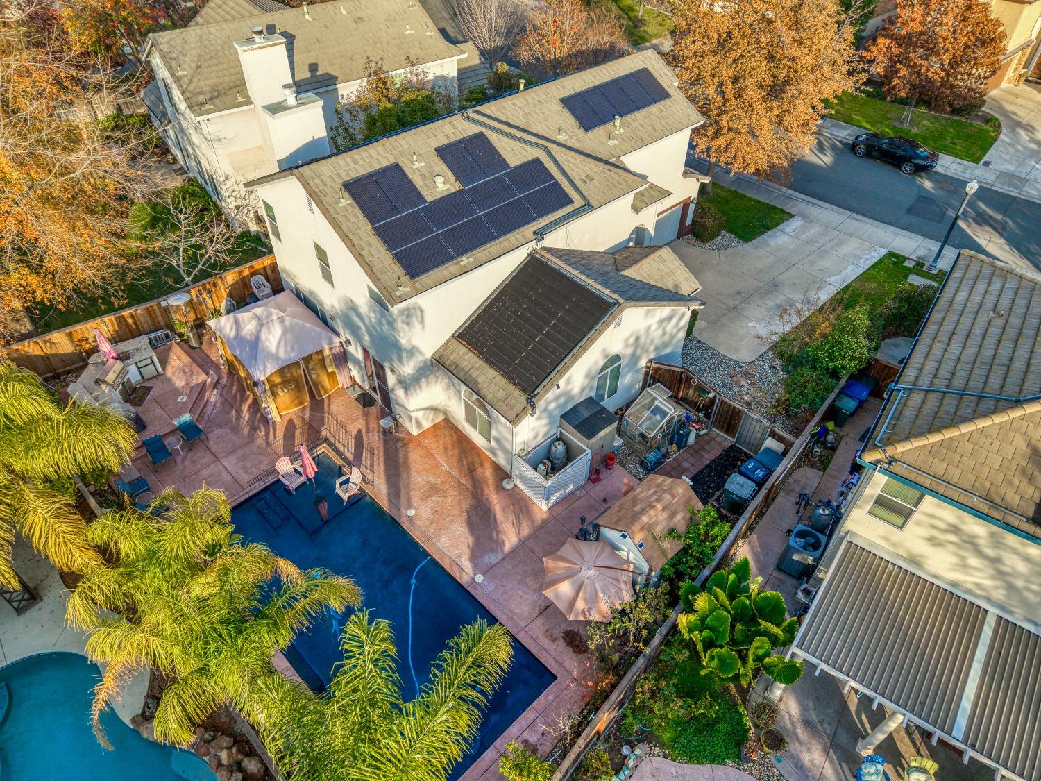 an aerial view of a house with a yard and garden