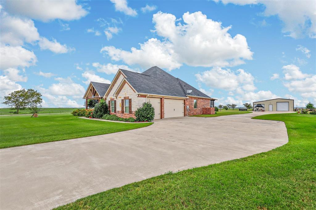 a view of house with yard and entertaining space