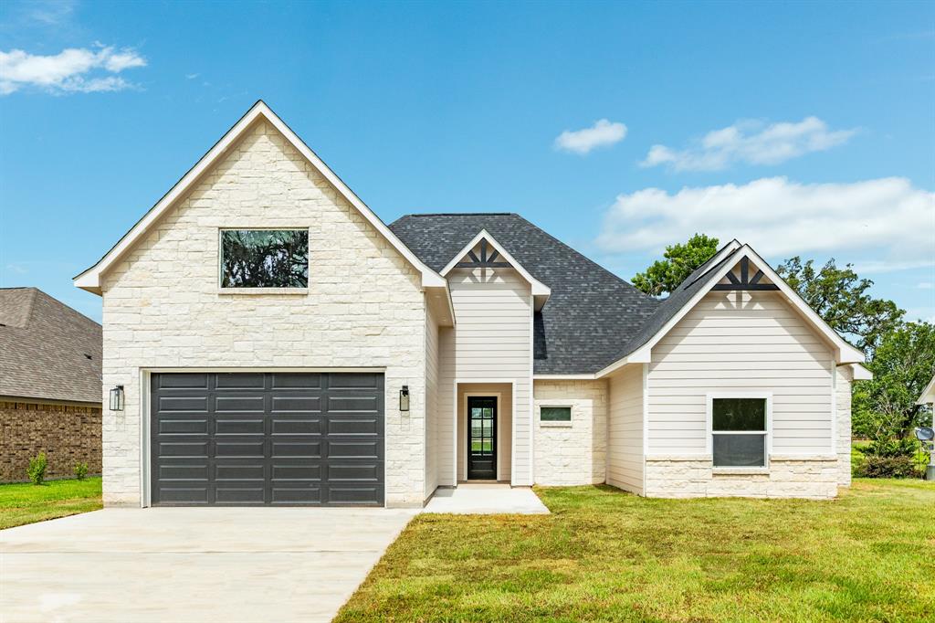 Front elevation includes stone and hardi. The garage was designed for larger vehicles.