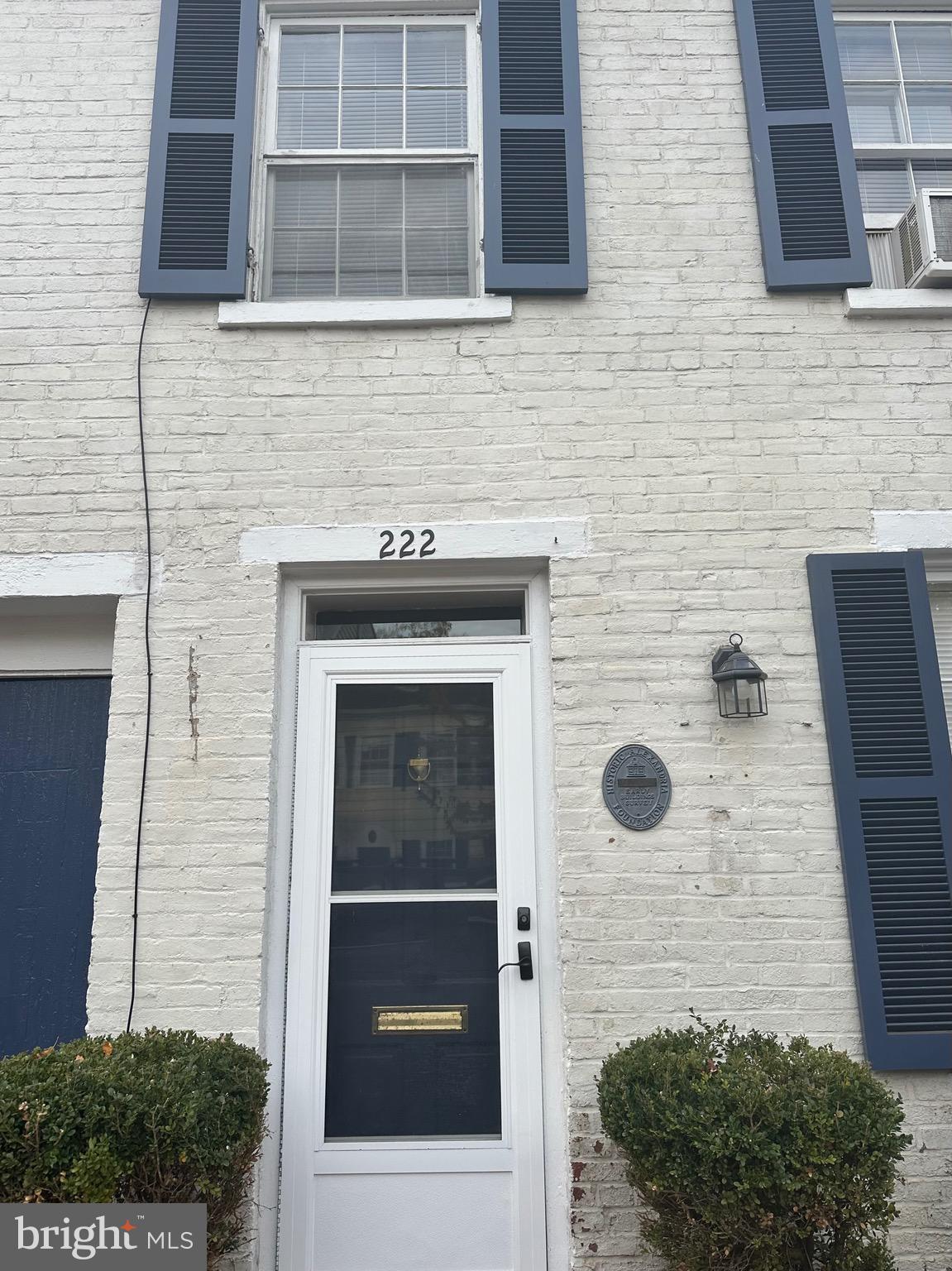 a brick house with a potted plant on it