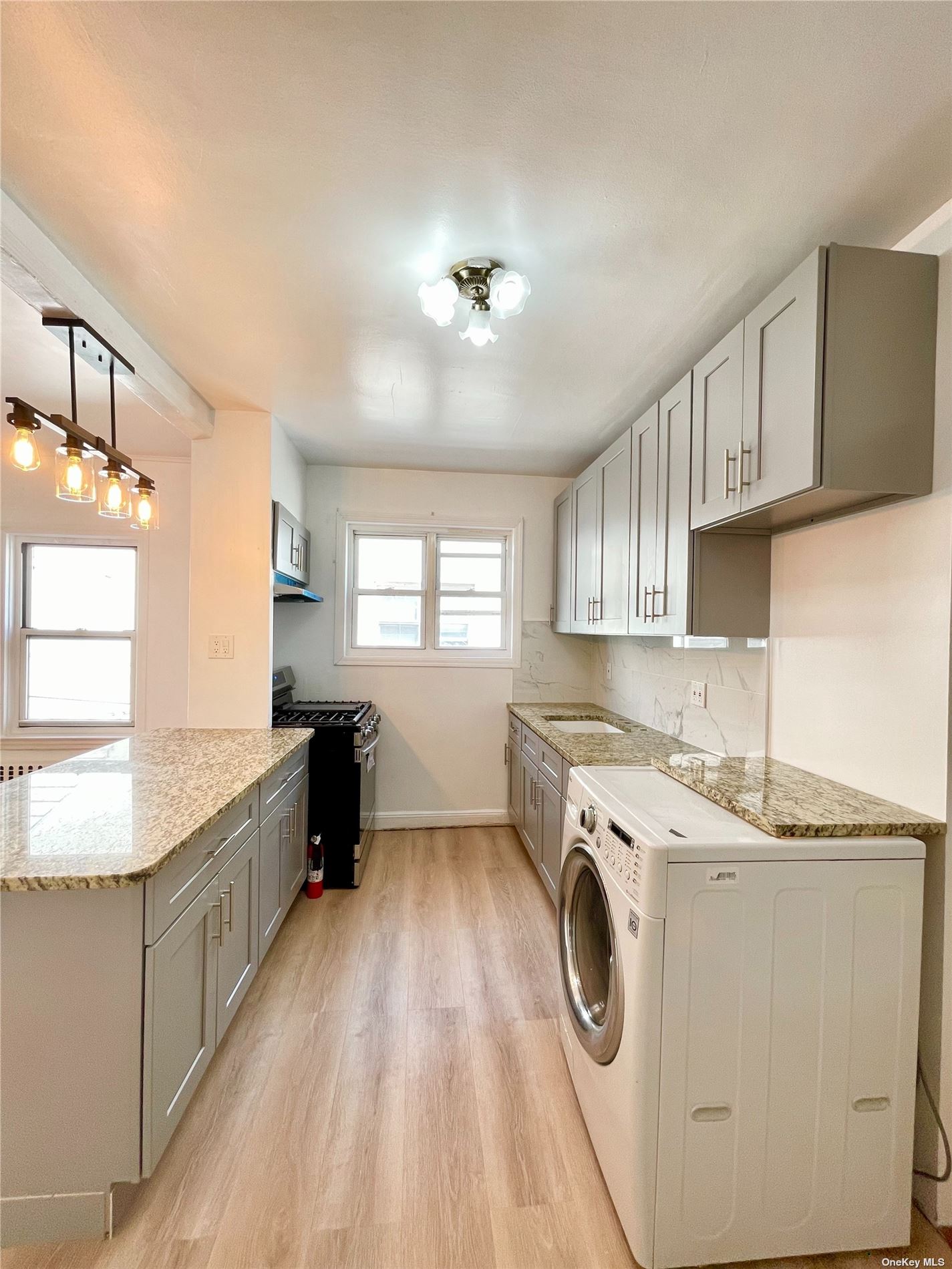 a utility room with cabinets washer and dryer