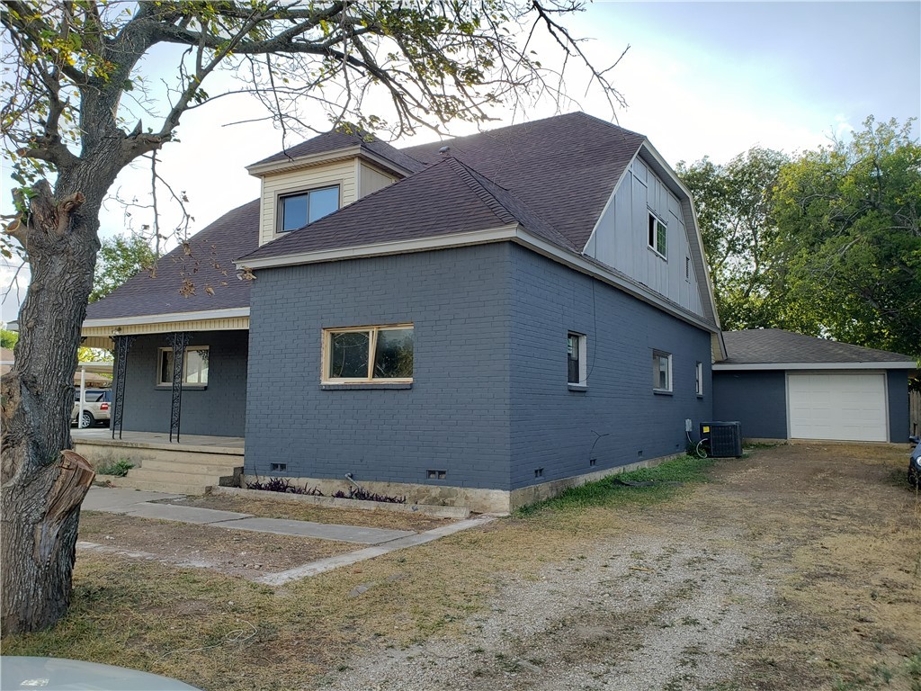 a house that has a tree in front of it