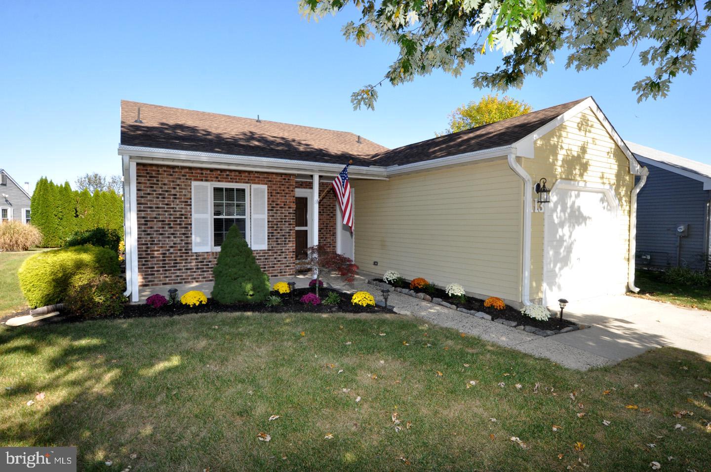 a view of a house with a small yard and potted plants