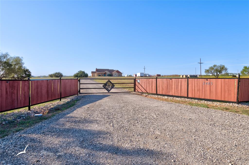 a view of a backyard with wooden fence