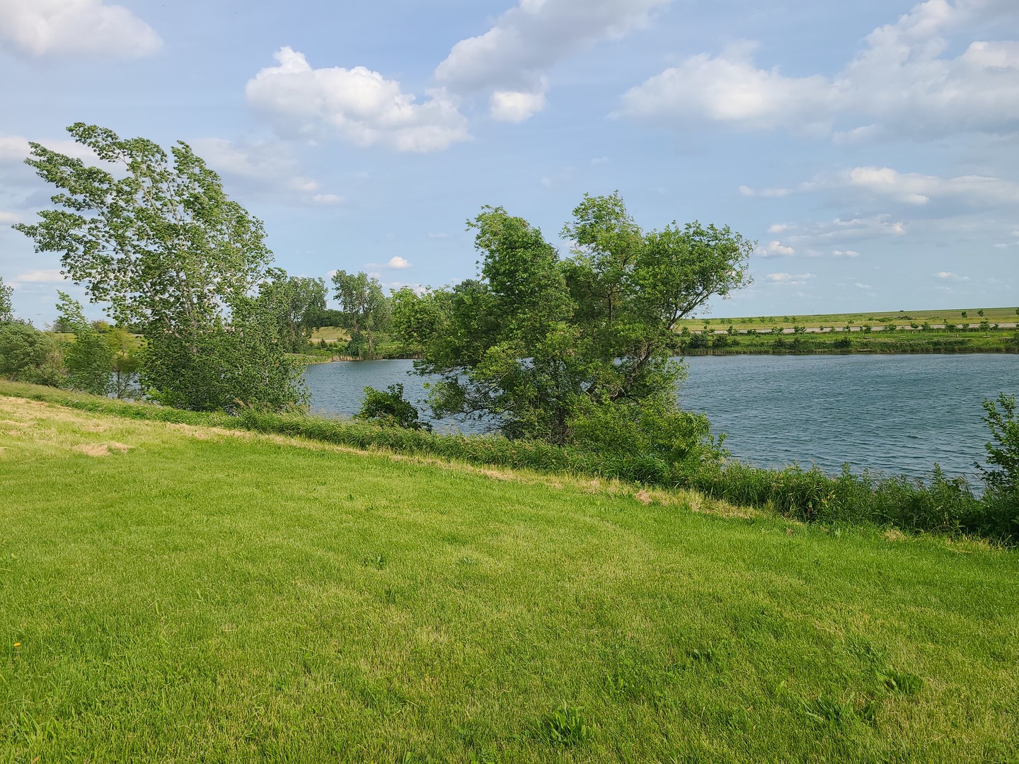 a view of a lake with a big yard