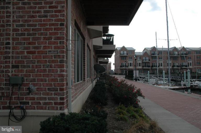 a view of a brick wall next to a building