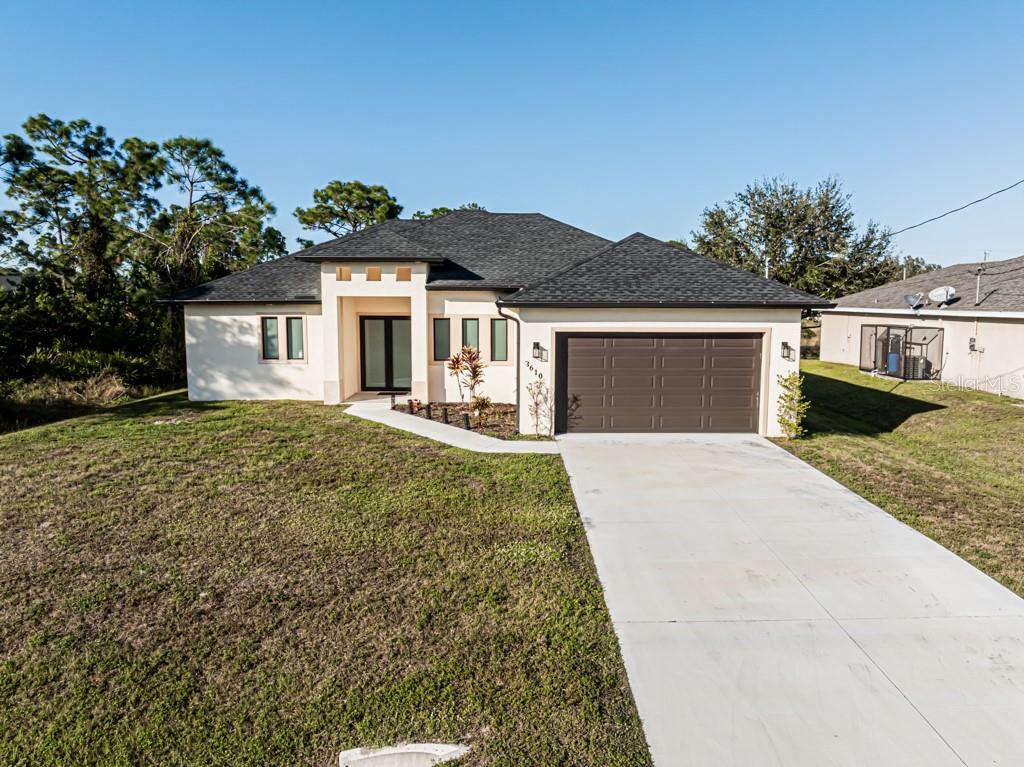 a front view of a house with a yard and garage