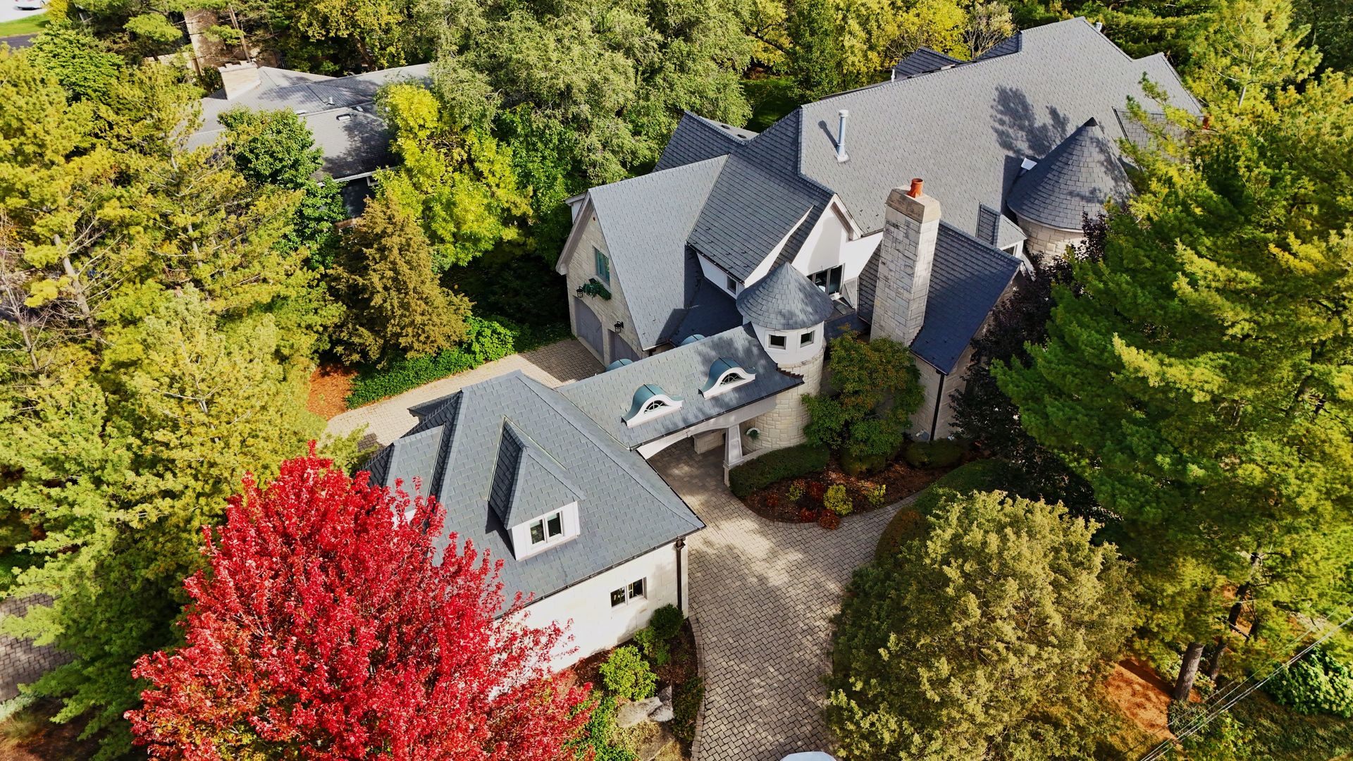 an aerial view of a house with a yard and garden