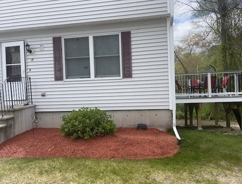 a view of a house with backyard and sitting area