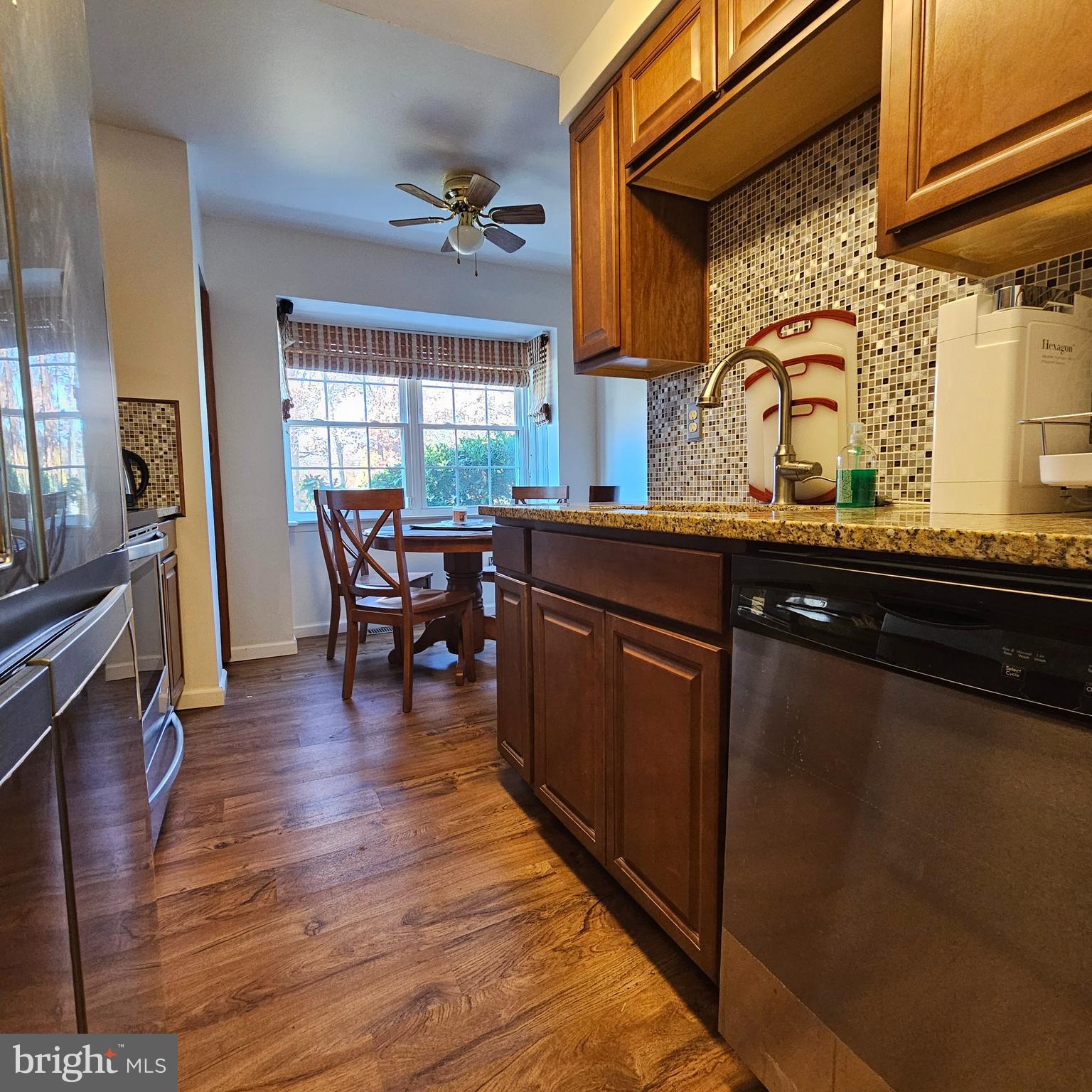 a kitchen with wooden floors and wooden cabinets