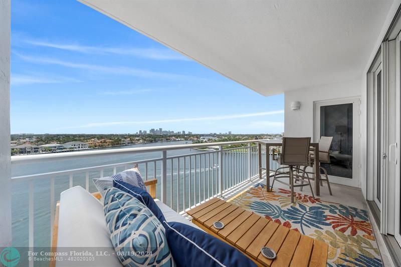 a view of a roof deck with furniture