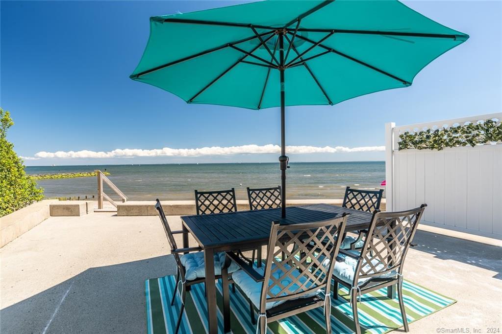 a view of an outdoor space with furniture and umbrella