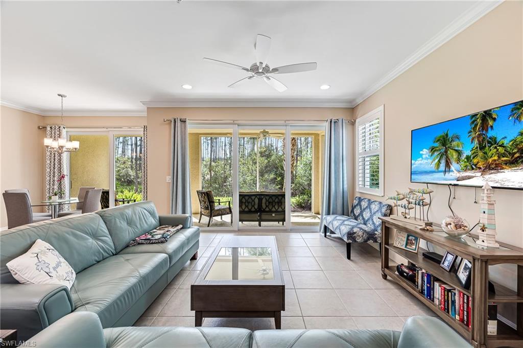 a living room with furniture large window and a flat screen tv