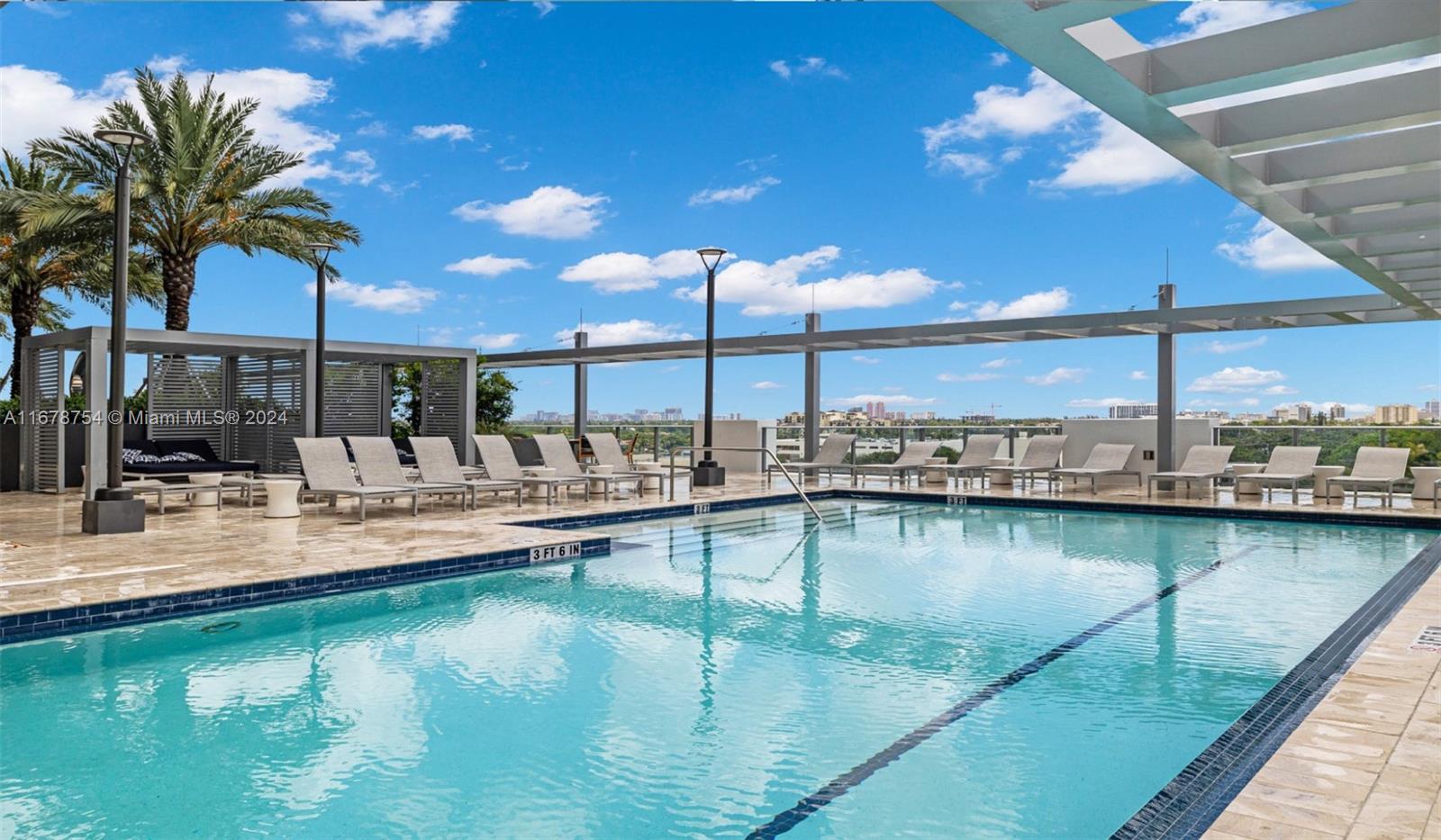 a view of a swimming pool with outdoor seating