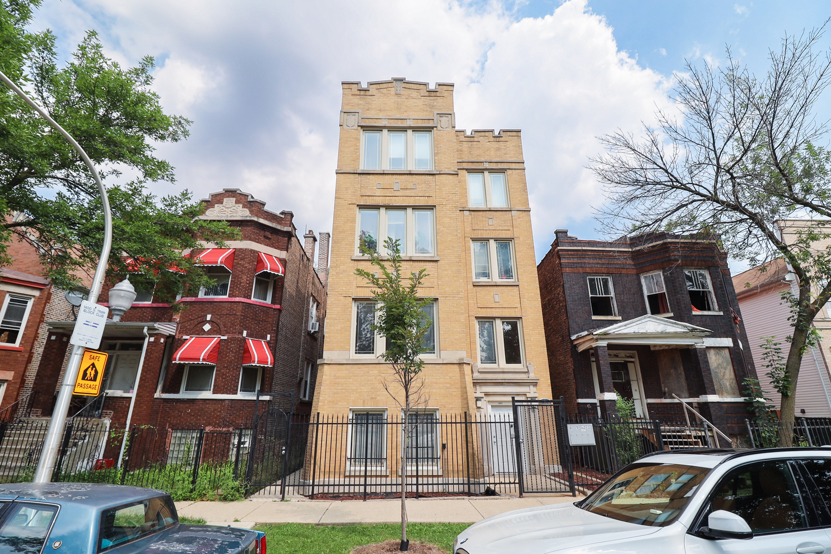 a front view of a residential apartment building with a yard