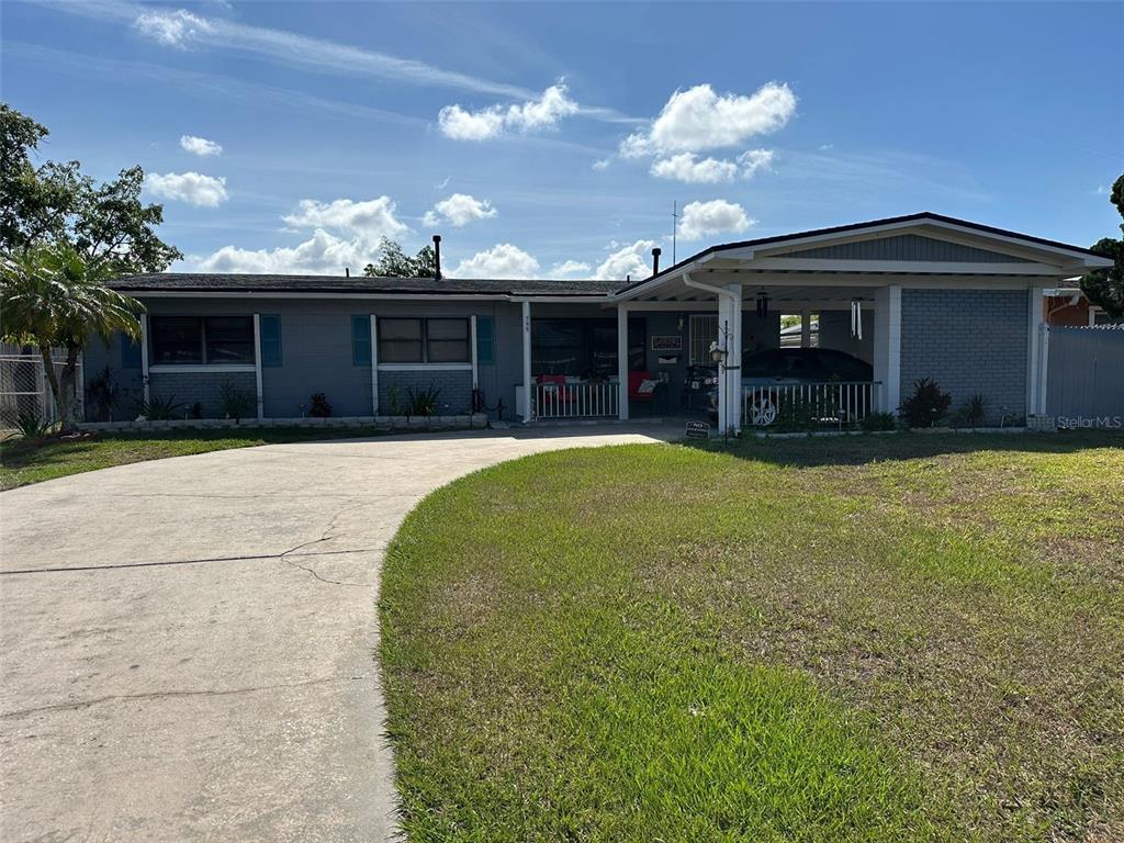 a view of a house with a yard and a garage