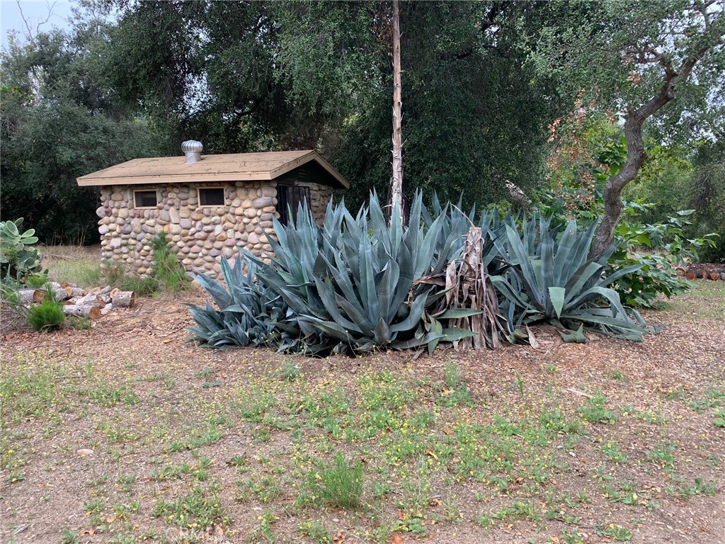 a view of a wooden house with a yard